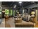 Contemporary living room featuring a comfortable gray sofa, stylish rug, and large windows with a view at 1860 Mountain Shadow, Stone Mountain, GA 30087