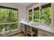 Sunlit office nook with built-in desk and drawers, featuring large windows with wooded views at 1860 Mountain Shadow, Stone Mountain, GA 30087