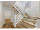 A bright staircase features wood steps, white railings, and decorative lighting at 1860 Mountain Shadow, Stone Mountain, GA 30087
