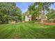Lush green backyard with well-maintained lawn and mature trees at 2117 Bucktrout Pl, Dunwoody, GA 30338