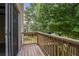 View of the wooden balcony overlooking greenery and the outside landscape at 2117 Bucktrout Pl, Dunwoody, GA 30338