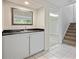 Basement area with tile flooring, countertops, a sink, and stairs to the upper level at 2117 Bucktrout Pl, Dunwoody, GA 30338