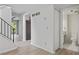 Hallway view of a bathroom featuring white tile and trim at 2117 Bucktrout Pl, Dunwoody, GA 30338