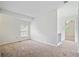 A bright bedroom with neutral carpet, a window, and entrance to another room at 2117 Bucktrout Pl, Dunwoody, GA 30338