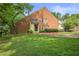 Charming brick two-story home with lush green lawn and mature trees at 2117 Bucktrout Pl, Dunwoody, GA 30338