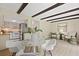 Charming living room with view into the kitchen and beamed ceilings creating a seamless flow throughout at 2117 Bucktrout Pl, Dunwoody, GA 30338