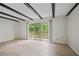 Living room featuring wood floors, beamed ceilings, and a sliding door to the outdoor patio at 2117 Bucktrout Pl, Dunwoody, GA 30338