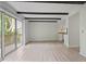 Living room featuring beamed ceiling, sliding glass doors and light wood-look flooring at 2117 Bucktrout Pl, Dunwoody, GA 30338
