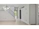 Living room featuring a staircase, chandelier, wood floors, and stainless steel refrigerator at 2117 Bucktrout Pl, Dunwoody, GA 30338