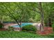 Community pool surrounded by trees and lounge chairs, perfect for relaxation at 2117 Bucktrout Pl, Dunwoody, GA 30338