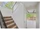 Staircase with a black handrail, carpeted stairs, and a view of the outdoor patio at 2117 Bucktrout Pl, Dunwoody, GA 30338