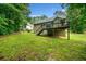 A spacious backyard features a wooden deck with stairs, offering an excellent outdoor living space at 4079 Essex Dr, Villa Rica, GA 30180
