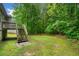 A lush backyard showcases a wooden deck with stairs and an expansive green lawn at 4079 Essex Dr, Villa Rica, GA 30180