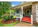 A covered front porch showcases charming details, including decorative columns and a cozy seating area at 4079 Essex Dr, Villa Rica, GA 30180