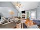 Bright living room with vaulted ceilings, a fireplace, large windows, and hardwood floors at 4079 Essex Dr, Villa Rica, GA 30180
