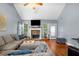 Inviting living room with stone fireplace, wood floors, and cozy sectional sofa at 4079 Essex Dr, Villa Rica, GA 30180