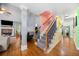 Hallway with a wooden staircase connecting to the living room fireplace and TV at 4079 Essex Dr, Villa Rica, GA 30180