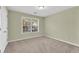 Comfortable bedroom with a carpeted floor and a window providing natural light at 1558 Park Knoll Trl, Lawrenceville, GA 30043