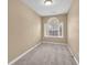 Empty bedroom with neutral walls, carpet, and a large window; ready for personalization at 1558 Park Knoll Trl, Lawrenceville, GA 30043