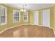 Inviting dining area with a chandelier, hardwood floors, and large windows at 1558 Park Knoll Trl, Lawrenceville, GA 30043