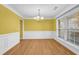 Dining room with yellow walls, hardwood floors, and a chandelier at 1558 Park Knoll Trl, Lawrenceville, GA 30043
