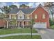 Charming two-story home with a well-manicured lawn and a two-car garage at 1558 Park Knoll Trl, Lawrenceville, GA 30043