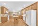 Spacious kitchen with an island, wooden cabinets, hardwood floors and modern appliances at 1558 Park Knoll Trl, Lawrenceville, GA 30043
