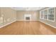 Spacious living room featuring hardwood floors, fireplace, and natural light at 1558 Park Knoll Trl, Lawrenceville, GA 30043