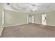 Spacious main bedroom with a tray ceiling and carpeted floors, bathed in natural light at 1558 Park Knoll Trl, Lawrenceville, GA 30043