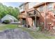 Backyard view with stone patio, wood decks, and a pool in the distance at 3194 Mill Springs Cir, Buford, GA 30519