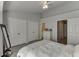 This bedroom features a ceiling fan, light gray walls, wood-look flooring, and ample closet space at 3194 Mill Springs Cir, Buford, GA 30519