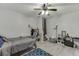 Bedroom featuring light gray walls, a ceiling fan, wood-look flooring, and modern decor at 3194 Mill Springs Cir, Buford, GA 30519