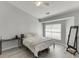 Cozy bedroom features a ceiling fan, a large window, and wood-look flooring at 3194 Mill Springs Cir, Buford, GA 30519
