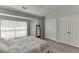 Bright bedroom with large window, light gray walls, and a ceiling fan at 3194 Mill Springs Cir, Buford, GA 30519