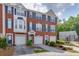 Charming brick townhome featuring a two-car garage, complemented by neat landscaping at 3194 Mill Springs Cir, Buford, GA 30519