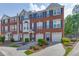 Charming brick townhome featuring a two-car garage, complemented by neat landscaping at 3194 Mill Springs Cir, Buford, GA 30519