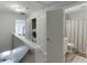 Bright hallway featuring a laundry closet and a bathroom with a shower/tub combo at 3194 Mill Springs Cir, Buford, GA 30519
