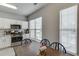 Modern kitchen includes stainless steel appliances, white cabinetry, granite countertops and natural light from a nearby window at 3194 Mill Springs Cir, Buford, GA 30519