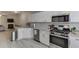 The kitchen features stainless steel appliances, granite countertops and modern white cabinetry at 3194 Mill Springs Cir, Buford, GA 30519