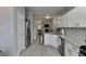 Modern kitchen features stainless steel appliances, granite counters and decorative backsplash that flows into living space at 3194 Mill Springs Cir, Buford, GA 30519