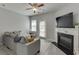 Cozy living room featuring a fireplace, ceiling fan, and a neutral color palette at 3194 Mill Springs Cir, Buford, GA 30519