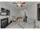 Comfortable living room with a fireplace, ceiling fan, grey floors and sectional couch at 3194 Mill Springs Cir, Buford, GA 30519