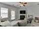 Cozy living room featuring a fireplace, ceiling fan, and a neutral color palette at 3194 Mill Springs Cir, Buford, GA 30519