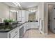 Bathroom featuring double sinks with granite counters, tile floors, and linen closet providing ample storage at 4700 Township Walk, Marietta, GA 30066