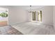 Open dining room with neutral paint and flooring, with a large window allowing light to flow in at 4700 Township Walk, Marietta, GA 30066