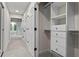 Hallway featuring a walk-in closet with custom shelves and drawers providing plenty of storage space throughout the home at 4700 Township Walk, Marietta, GA 30066