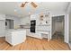 Bright kitchen with white cabinets, hardwood floors, and a built-in desk and shelving unit at 4700 Township Walk, Marietta, GA 30066