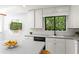 Bright kitchen featuring white cabinets, a garden view, and modern appliances, perfect for cooking and entertaining at 4700 Township Walk, Marietta, GA 30066