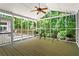 Light-filled screened porch with ceiling fan overlooking a wooded backyard, perfect for enjoying the outdoors at 4700 Township Walk, Marietta, GA 30066