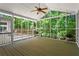 Light-filled screened porch with ceiling fan overlooking a wooded backyard, perfect for enjoying the outdoors at 4700 Township Walk, Marietta, GA 30066
